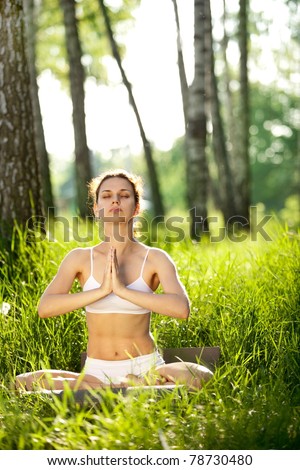 Practicing of yoga outdoors.