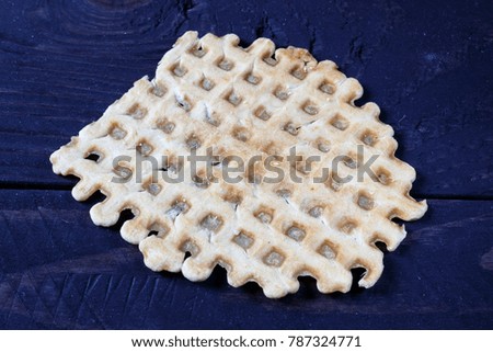 Flat waffles closeup on wooden background