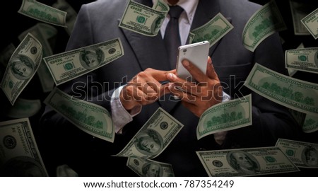 Business man use smart phone for business succession and A lot of banknote dollar falling like a rain.