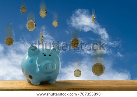 euro coins falling on a piggybank - money rain