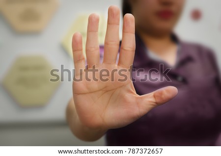 A person showing an open hand signal that means stop or wait isolated on a blurred background Royalty-Free Stock Photo #787372657