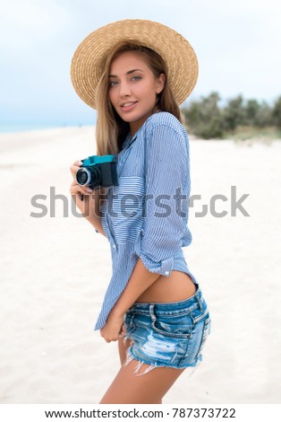 Beautiful woman wearing hat and shorts white beach,Minimal style and pastel tone.copy space,spring,summer,travel tips,planing,flight 