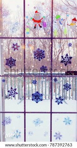 Snowflake and cartoon sticker on the window for Christmas decorations in a house in united states.