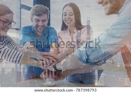 Double exposure, panoramic view contemporary megalopolis background. Photo of a young startup business team happy for a successful contract and looking city. 