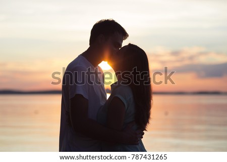 loving couple kissing at sunset. love in the sun. Valentine's day in nature beach Royalty-Free Stock Photo #787431265