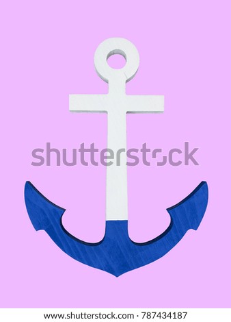 Wooden painted anchor on a pink background