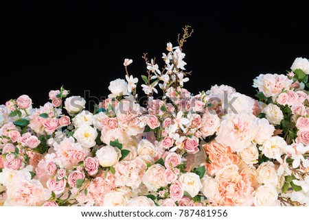 colorful artificial flowers for decoration on black background with copy space. 