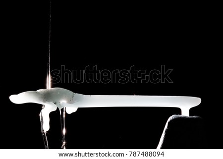 Dripping wax on a horizontal wax bar shaped figure.