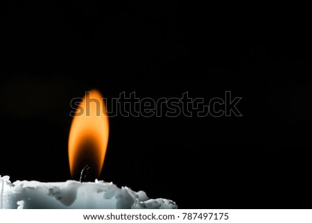 Burning candles on black background