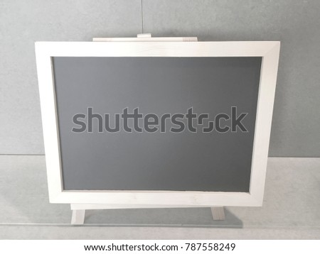 Blank blackboard standing on table, space for text