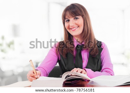 Pretty young woman studying in a class room