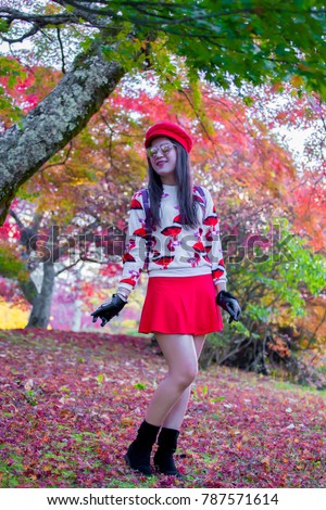 Cute Asian women wears fashion costume dress and takes pictures around Japan Country during travel on autumn season.