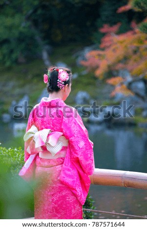 Cute Asian women wears fashion costume dress and takes pictures around Japan Country during travel on autumn season.