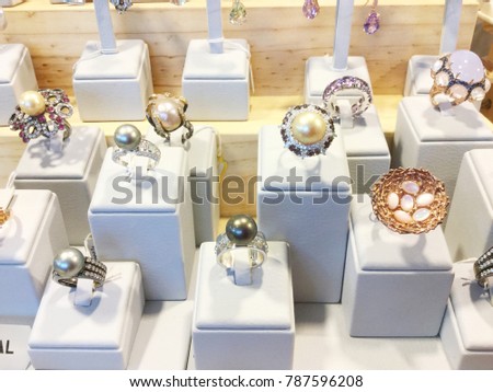 Ring with gems at showcase of jewelry shop