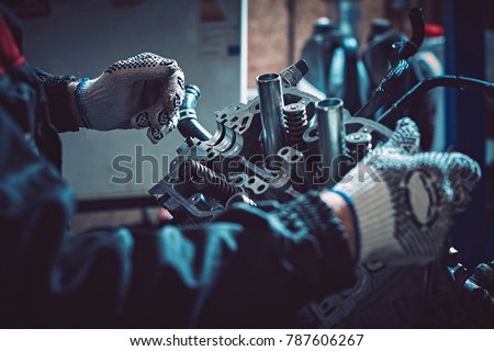 Closeup repair of an opposing engine by an auto mechanic. Diagnosis and disassembly of parts for repair. Royalty-Free Stock Photo #787606267