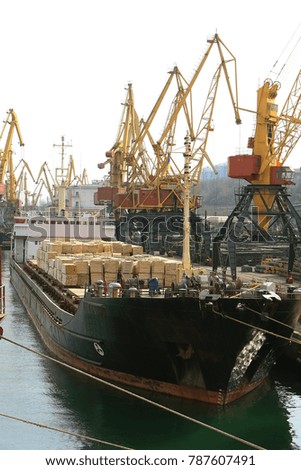 ODESSA, Industrial container cargo cargo ship with a working crane. Cargo container ship in the dock. Delivery of containers. Logistics import export and transport industry