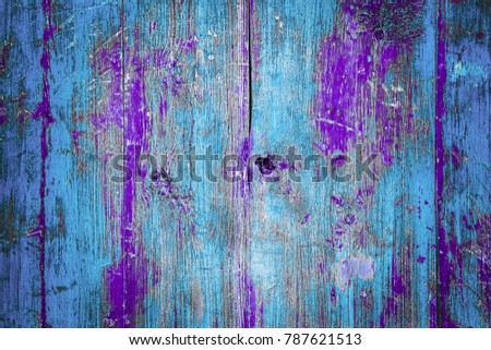 Abstract background of an old wooden wall with a bright texture. Planks in contrast, blue, turquoise, and purple