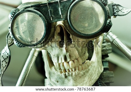 Human skull with insane look and goggles (robot)