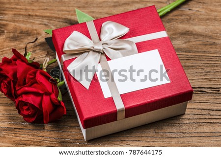 Rose and present gift on wooden background/ Valentines day background,Valentine's day little card