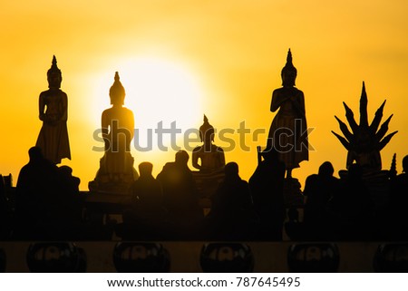 Silhouette buddha statues on blurred sunset background.Thailand