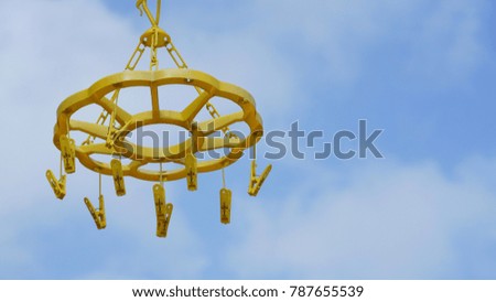 Yellow cloth claw with sky background.