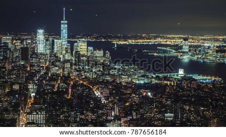 USA, New York City, Manhattan aerial panorama cityscape skyline. Lights of the city at night, traffic of cars, planes and ships on the river