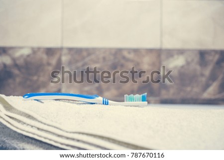 Blurred bathroom interior background and white spa towels on Marble Toothbrush razor