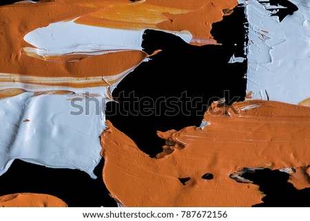   white and orange  oil paint brush strokes texture background  -mixing on a black palette