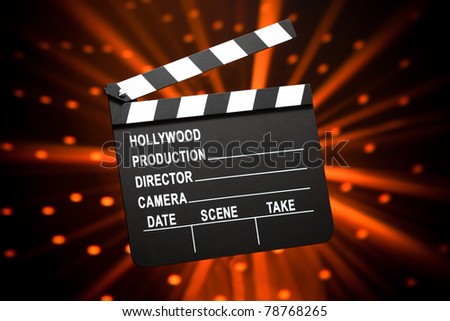 clapperboard against shiny background