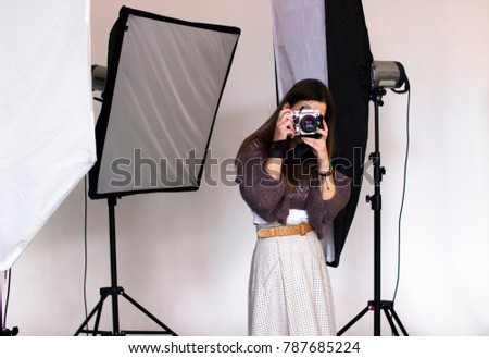 backstage photo shoot in the studio with professional equipment, the photographer takes a picture 