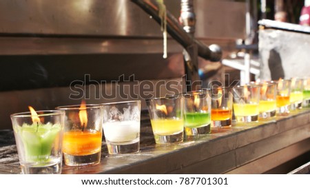 Row of candle light in tumblers in temple north of thailand, focus at tumblers