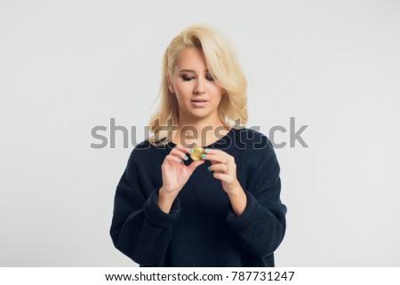 Portrait of a young blonde businesswoman wearing a black shirt, bitcoin