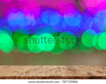 Empty wooden floor. blurred colorful bokeh light background. There is an empty space for productions