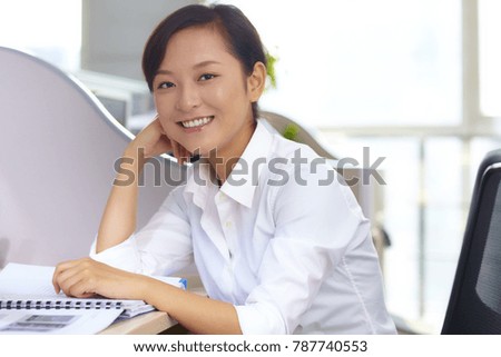 one pretty young asian businesswoman in office