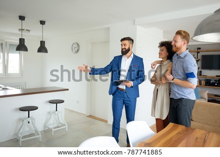 Young couple with a real estate agent. Buying a new house.