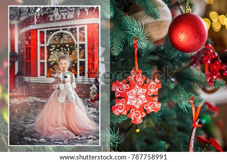 Beautiful little baby girl in dress holding  teddy bear, on the background of the showcase red with toys. Christmas decoration on the Christmas tree