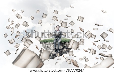 Funny man in red glasses and suit sitting on floating island and reading book