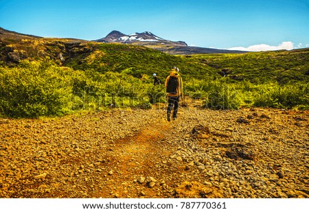 Traveler against  picturesque Icelandic landscape.