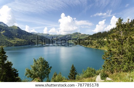Gormet de Roselend, France: Lake of the Passo and church on the path.