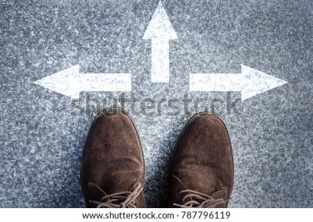 man standing on road with three direction arrow choices, left, right or move forward