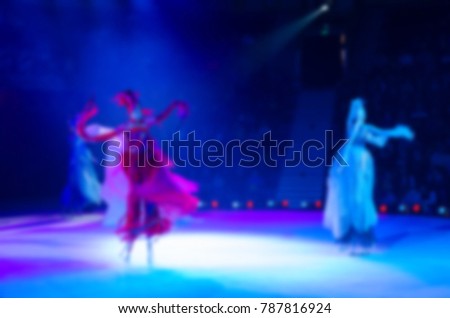 Abstract blurred image of tour of circus on ice. Skating on stilts in defocus, background