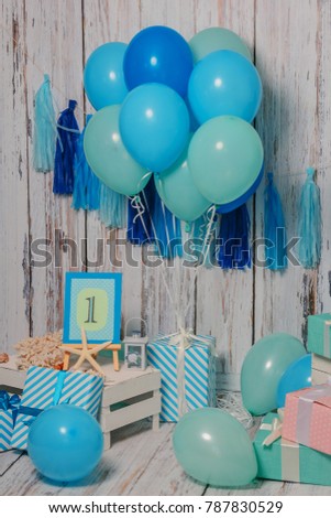 Sea decor on a wooden background with balloons and gifts