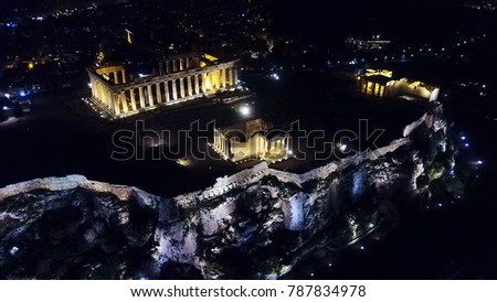 Aerial birds eye view night photo taken by drone of iconic Acropolis hill, the Parthenon and Erechtheion, Athens historic center, Attica, Greece
