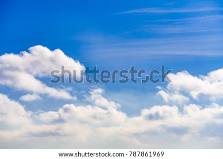 White fluffy clouds in the bright blue sky 