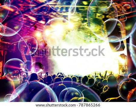 Soap bubbles falling on a concert crowd