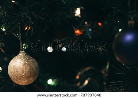 holiday decorations hang on a Christmas tree