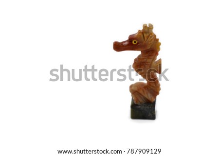 Seahorse statue stock images. Seahorse isolated on a white background. Carved stone seahorse