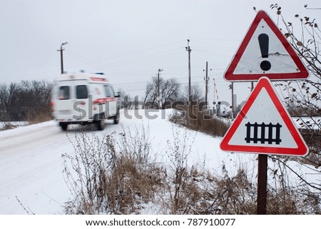 the ambulance rushes past the sign railway crossing
