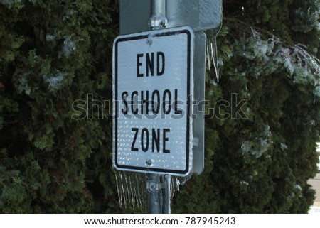 end school sign encased in ice