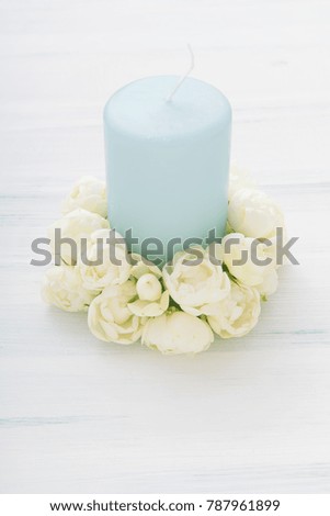 White miniature rose and candle